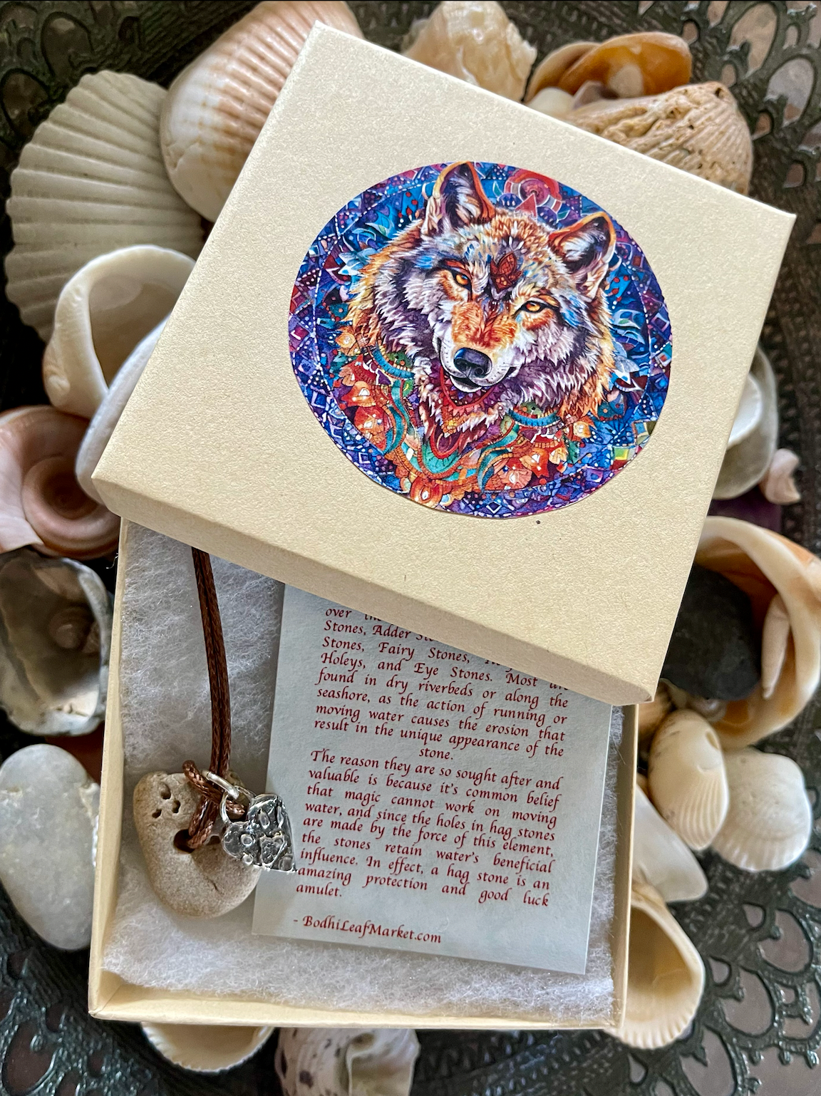 wolf, wolf gift, florida wolf, boxed gift, wolf paw, paw charm, paw heart charm, local beach stone, hagstone, hagstone pendant, Bodhi Leaf Market, April 2025, USA, Made in USA, made in Florida, Florida stone, original wolf artwork, holey stone, witch's stone, fairy stone, wolf stone